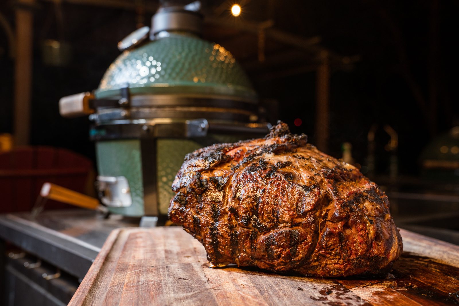 Roasted prime rib beside a Big Green Egg