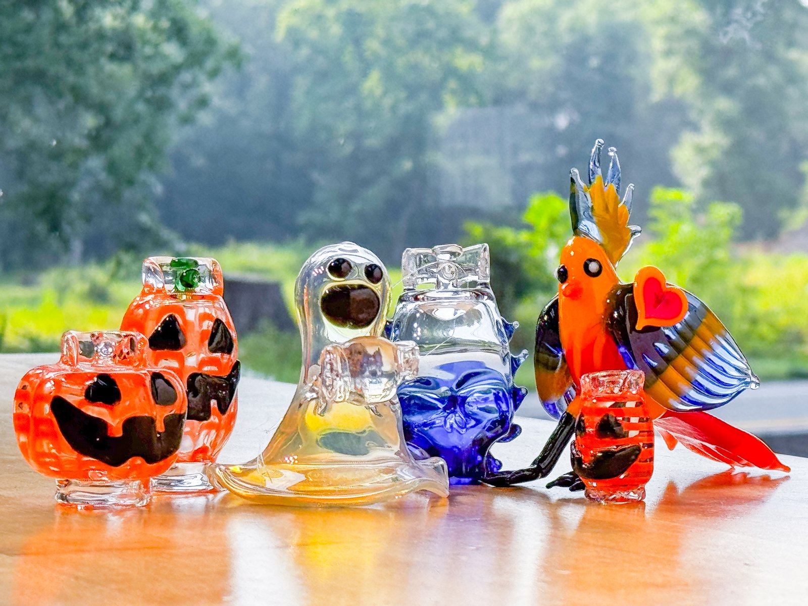 Hand-blown glass pumpkin and ghost figurines with a Pumpkin Spice Propane sticker